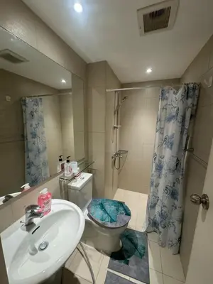 a bathroom with a sink and a toilet and a shower at Azure Urban Dream Staycation in Manila