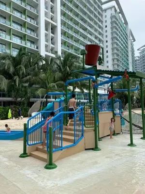 a playground at the beach with people playing on it at Azure Urban Dream Staycation in Manila