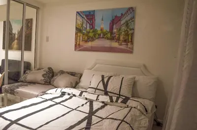 a bedroom with a bed and a painting on the wall at Azure Urban Dream Staycation in Manila