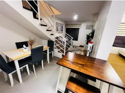 a small apartment with a dining room and a staircase at Porto Vita Towers in Manila