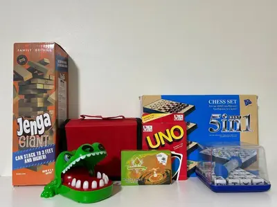 a table topped with boxes of snacks and a dinosaur toy at 1BR Calathea Place nr Airport, Netflix,50mbps Wifi in Manila