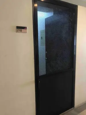 a black door with a mirror in a room at 1BR Calathea Place nr Airport, Netflix,50mbps Wifi in Manila