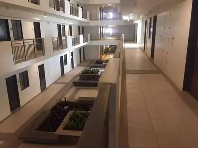 an empty hallway of a building with plants at 1BR Calathea Place nr Airport, Netflix,50mbps Wifi in Manila