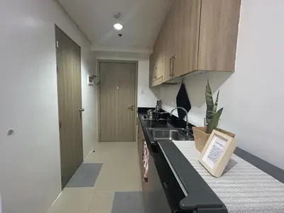 a kitchen with a sink and a counter top at Shore 1 Residences Tower B in Manila
