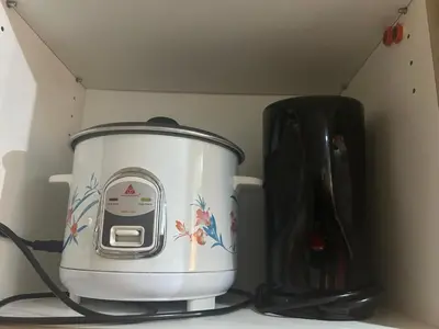 a slow cooker sitting on a counter next to a blender at Shore 1 Residences Tower B in Manila
