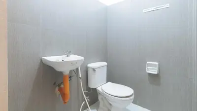 a bathroom with a toilet and a sink at RedDoorz at Najar Residences near NAIA Terminal in Manila