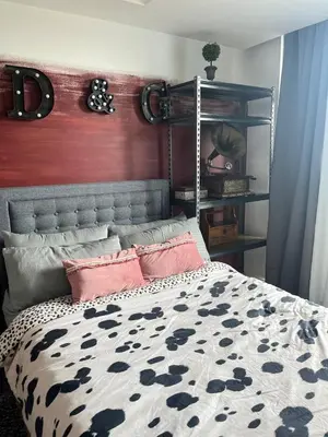 a bedroom with a bed with a metal head board at Alphas Haven in Manila