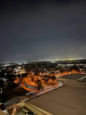 a view of a city at night with lights at Alphas Haven in Manila