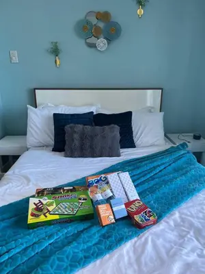 a bed with two books on top of it at Alphas Haven in Manila