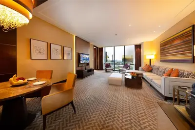 a living room with a couch and a table at City Of Dreams - Nüwa Manila in Manila