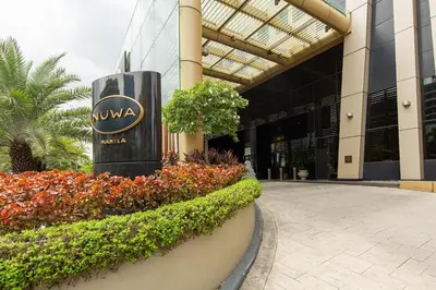 a sign in front of a building with flowers at City Of Dreams - Nüwa Manila in Manila