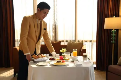 a man standing next to a table with food on it at City Of Dreams - Nüwa Manila in Manila