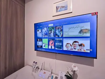 a flat screen tv hanging on a wall at 1BR Condotel with Balcony at FAME Residences #FM58 in Manila