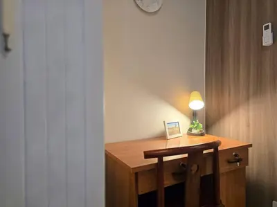 a wooden desk with a lamp on top of it at 1BR Condotel with Balcony at FAME Residences #FM58 in Manila