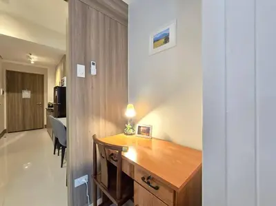 a wooden desk in a room with a hallway at 1BR Condotel with Balcony at FAME Residences #FM59 in Manila