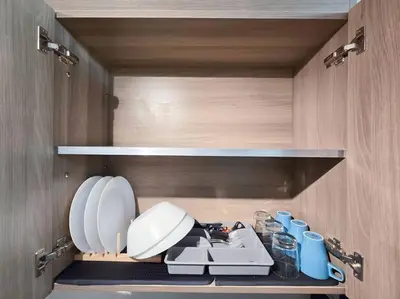 a kitchen with a sink and cups on a shelf at 1BR Condotel with Balcony at FAME Residences #FM59 in Manila