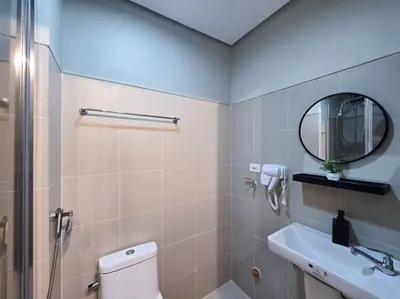 a bathroom with a toilet and a sink and a mirror at 1BR Condotel with Balcony at FAME Residences #FM60 in Manila
