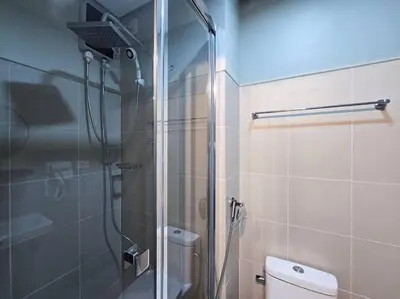 a bathroom with a shower and a toilet at 1BR Condotel with Balcony at FAME Residences #FM60 in Manila