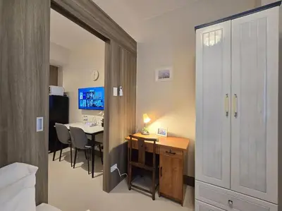a room with a desk and a table in a room at 1BR Condotel with Balcony at FAME Residences #FM60 in Manila