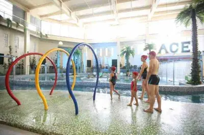 a group of people playing in a swimming pool at Budget Twin-1Bedroom at Ace Suites in Manila