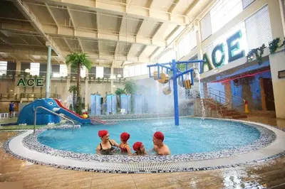 a group of three people in a swimming pool at Budget Twin-1Bedroom at Ace Suites in Manila