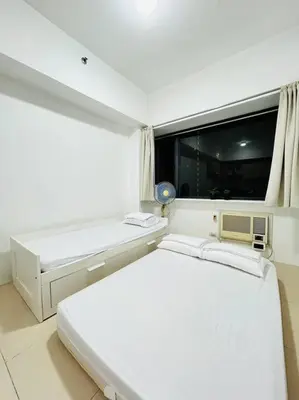 a white room with a bed and a window at Budget Twin-1Bedroom at Ace Suites in Manila