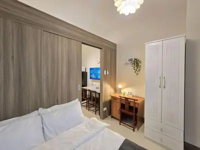 a bedroom with a bed and a desk and a desk at 1BR Condotel with Balcony at FAME Residences #FM61 in Manila