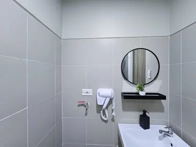 a white bathroom with a sink and a mirror at 1BR Condotel with Balcony at FAME Residences #FM61 in Manila