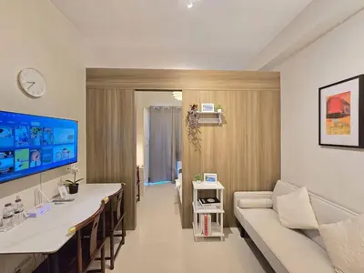 a living room with a couch and a table at 1BR Condotel with Balcony at FAME Residences #FM61 in Manila
