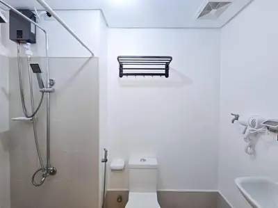 a white bathroom with a toilet and a sink at 1BR Condotel with Balcony at SM Light Residences #LT08 in Manila