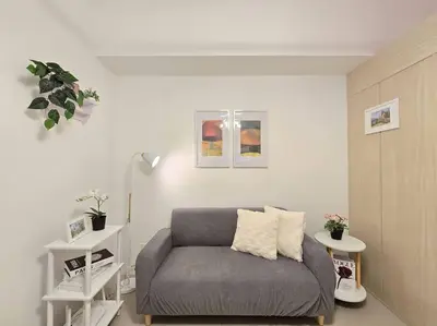 a living room with a gray couch in a room at 1BR Condotel with Balcony at SM Light Residences #LT08 in Manila