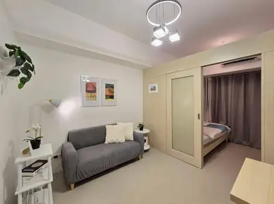 a living room with a couch and a bed at 1BR Condotel with Balcony at SM Light Residences #LT08 in Manila
