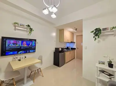 a living room with a table and a kitchen at 1BR Condotel with Balcony at SM Light Residences #LT08 in Manila