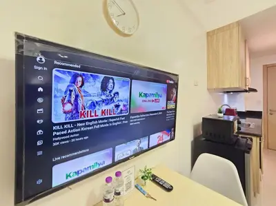 a large flat screen tv hanging on a wall at 1BR Condotel with Balcony at SM Light Residences #LT09 in Manila