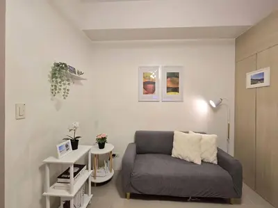 a living room with a couch and a table at 1BR Condotel with Balcony at SM Light Residences #LT09 in Manila