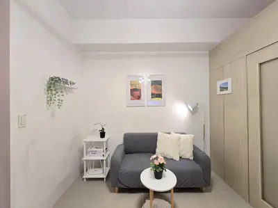 a living room with a couch and a table at 1BR Condotel with Balcony at SM Light Residences #LT09 in Manila