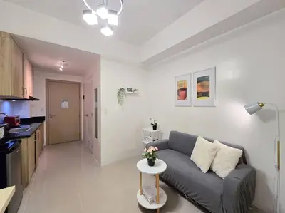 a living room with a couch and a table at 1BR Condotel with Balcony at SM Light Residences #LT09 in Manila