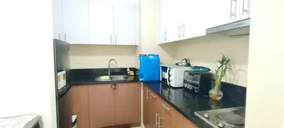 a kitchen with a sink and a microwave at 1 Bedroom unit near NAIA T3 in Manila