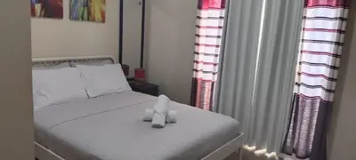 a bedroom with a bed with two candles on it at 1 Bedroom unit near NAIA T3 in Manila