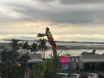 a statue of a man standing on top of a city at Shore Family Suite 2 Beds WiFi TV Netflix Near MOA 9120 in Manila