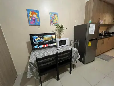 a table with a computer on top of it in a kitchen at Shore Family Suite 2 Beds WiFi TV Netflix Near MOA 9120 in Manila