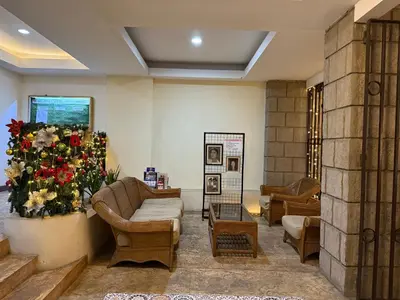 a living room with a couch and a flower arrangement at Angsana Breeze at Paseo Verde Las Piñas in Manila