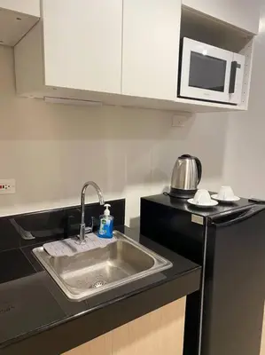 a kitchen with a sink and a microwave at SMDC Park Residences near SM City Sta Rosa unit 1 in Ibaba