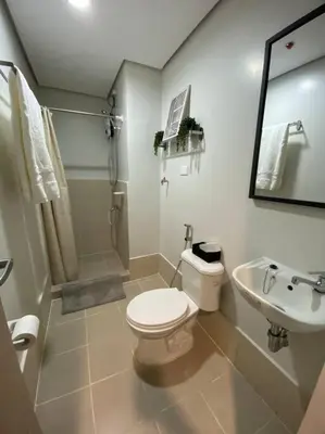 a white bathroom with a toilet and a sink at SMDC Park Residences near SM City Sta Rosa unit 1 in Ibaba