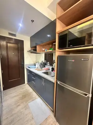 a kitchen with a stainless steel refrigerator and a sink at Cozy Unit Right by the Pool with Massage in Silang