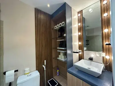 a bathroom with a white sink and a mirror at Cozy Unit Right by the Pool with Massage in Silang