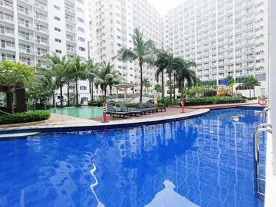 a large blue swimming pool with buildings in the background at Sosyal Staycation , Pasay City Shore Residences Tower D Sunrise Drive Mall of Asia Complex Pasay City Philippines SMDC SHORE 1 RESIDENCES Pasay City in Manila