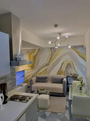 a living room with a couch and a painting on the wall at Azure Staycation - Parañaque in Manila
