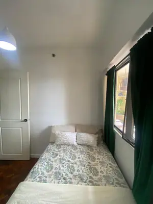 a small bed in a room with a window at Raya Garden Vacation Home 2 bedroom sunset view in Manila