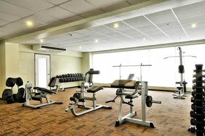 a gym with several treadmills and cardio machines at Raya Garden Vacation Home 2 bedroom sunset view in Manila